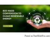 The image shows a hand holding a glass ball with a recycling symbol on it. The background is blurred, but it appears to be a...