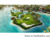 The image is an aerial view of a beautiful tropical resort. The resort is located on a small island in the middle of the ocea...