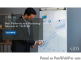 The image shows a man in a suit standing in front of a whiteboard with graphs and charts on it. He is holding a pen and appea...