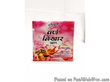The image is a photograph of a packet of Indian tea. The packet is rectangular in shape and has a pink background with a flor...