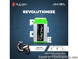 The image is an advertisement for Ruchira Green Earth's Akira Lithium-ion batteries. The background of the image is a citysca...