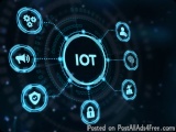 The image is a digital illustration of the word "IOT" in the center of a circular frame. Surrounding the word are various ico...