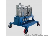 The image shows a blue-colored industrial machine with four wheels. The machine appears to be made of metal and has a rectang...
