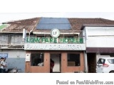 The image shows the exterior of a hotel named "Low Fare Hotels Family Dormitory". The hotel is located on a street corner wit...