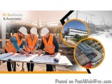 The image shows three construction workers wearing orange high visibility vests and white hard hats, standing at a table and...