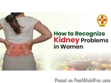 The image shows a woman standing with her back to the camera, facing away from the camera. She is wearing a white top and gre...