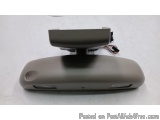 The image shows a gray-colored electronic device, which appears to be a remote control or a device used to control a car's au...