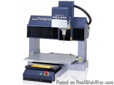 The image shows a Roland MDX-540 CNC (Computer Numerical Control) machine. It is a large, industrial-looking machine with a b...