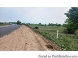 The image shows a dirt road with a small hole in the ground on the right side. The road appears to be empty and there are no...