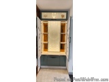 The image shows a corner of a room with a built-in wardrobe. The wardrobe has a white door with a glass panel in the center,...