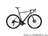 The image is of a black and silver road bike. The bike has a sleek design with a black frame and silver accents. It has a bla...