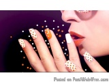 The image is a close-up of a woman's hand with her fingers spread out. The nails are painted with a white base color and are...