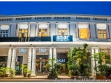 The image shows the exterior of a hotel named "Chido" and "Asar". The hotel is located in a modern building with a white faca...