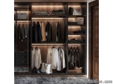 The image shows a modern and luxurious walk-in closet with a wooden wardrobe. The wardrobe has a large wooden door on the rig...