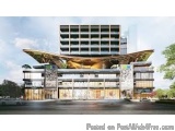 The image is a digital rendering of a modern building with a unique architectural design. The building is a two-story structu...
