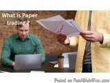 The image shows a man sitting at a desk with a laptop and a coffee cup in front of him. He is wearing a green shirt and appea...