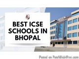 The image shows a modern building with a blue sky in the background. The building appears to be a school or college, as indic...