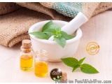 The image shows a white mortar and pestle with fresh mint leaves in it. The mortar is placed on a wooden surface with a burla...