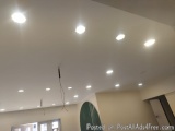 The image shows a room with a white ceiling and multiple recessed lights. The ceiling is covered with a light fixture that is...