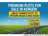 The image shows a road with two yellow signs on either side. The road is in the middle of a green field with a blue sky in th...