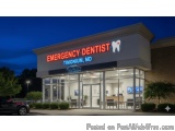 The image shows the exterior of an emergency dentist clinic at night. The clinic is located in Timonium, MD and is located on...