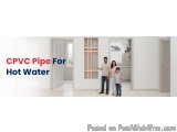 The image shows a family of three - a man, a woman and a child - standing in an empty room with white walls and wooden floori...