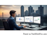 The image shows a man sitting at a desk in front of three computer monitors. He is wearing a dark suit and appears to be focu...