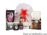 The image is of a gift basket filled with various items. The basket is made of white paper and has a red ribbon tied in a bow...