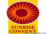 The image is a logo for Sunrise Convent. It is a circular emblem with a red and orange color scheme. The center of the emblem...