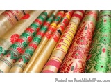 The image shows a close-up of a collection of colorful fabrics. There are six rolls of fabric in total, arranged in a neat an...