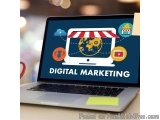 The image shows a laptop with a blue screen that displays the words "DIGITAL MARKETING" in white text. On the screen, there i...