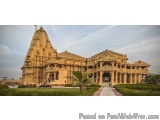The image shows a large, ornate temple with a unique architectural design. The temple is made of stone and has multiple level...