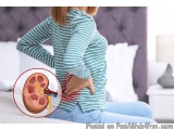 The image shows a woman sitting on a bed with her back to the camera. She is wearing a green and white striped long-sleeved s...
