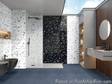 The image shows a modern bathroom with a minimalist design. The walls are covered in white tiles with black and white speckle...