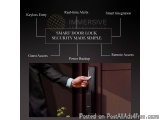 The image shows a person's hand opening a smart door lock. The door lock is black and has a keyless entry feature. It is a de...