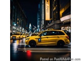 The image is a photograph of a busy city street at night. The street is lined with tall buildings on both sides, and the buil...