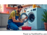 In this image, we can see a young man in a kitchen, kneeling on the floor and fixing a washing machine. He is wearing a yello...