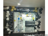 The image shows the entrance of a store named "Let Wizard Con". The entrance is decorated with a large arch made of black and...