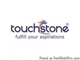 The image is a logo for a company called Touchstone. The logo is written in a modern, sans-serif font and is in a dark blue c...
