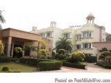 The image shows a large, two-story building with a white exterior and a pink dome on top. The building is called "Park Ridge"...