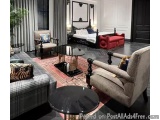 The image shows a luxurious living room with a modern and elegant design. The room has a large window with sheer curtains on...