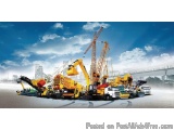 The image shows a group of construction vehicles, including cranes and trucks, parked on a construction site. The vehicles ar...