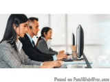 The image shows a group of three people working in a call center. They are all wearing headsets and are sitting at a desk wit...