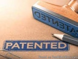 The image shows a blue rubber stamp with the word "PATENTED" written on it in white capital letters. The stamp is placed on a...