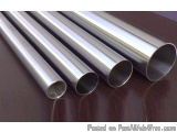 The image shows four stainless steel pipes of different sizes and lengths. The pipes are arranged in a horizontal line on a w...