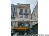 The image shows the entrance of a building named "Lakme Academy" in Mumbai, India. The building is a two-story structure with...