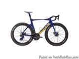 The image is of a blue and yellow Bianchi road bike. The bike has a sleek design with a black saddle and handlebars. The fram...