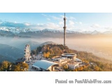 The image is an aerial view of a beautiful landscape with a tall tower in the center. The tower is a tall, cylindrical struct...