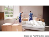 The image shows two men in a living room, unloading boxes from a white sofa. They are both wearing blue t-shirts and appear t...