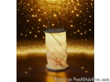 The image is of a small lantern with a black handle. The lantern is made of paper and has a unique design with a criss-cross...